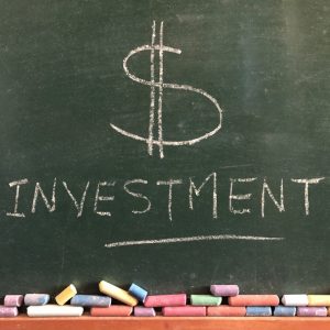 investment written in chalk on a chalkboard creative concept banking and finance t20 NxQKZQ